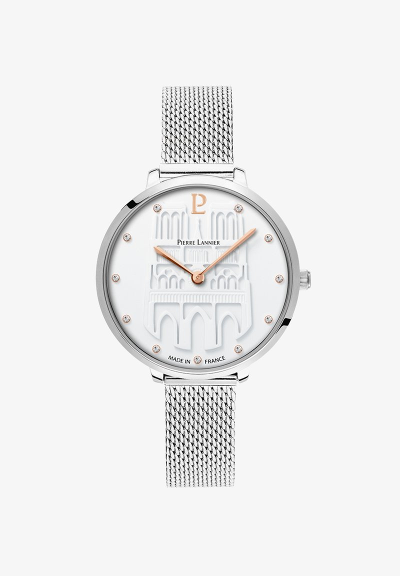 Sidzs sudraba sieta josla ar baltu teksturētu ciparnīcu, reljefa dizainu, rozā zelta rādītājiem un kristāla akcentiem. Zīmola nosaukums ir redzams uz ciparnīcas.