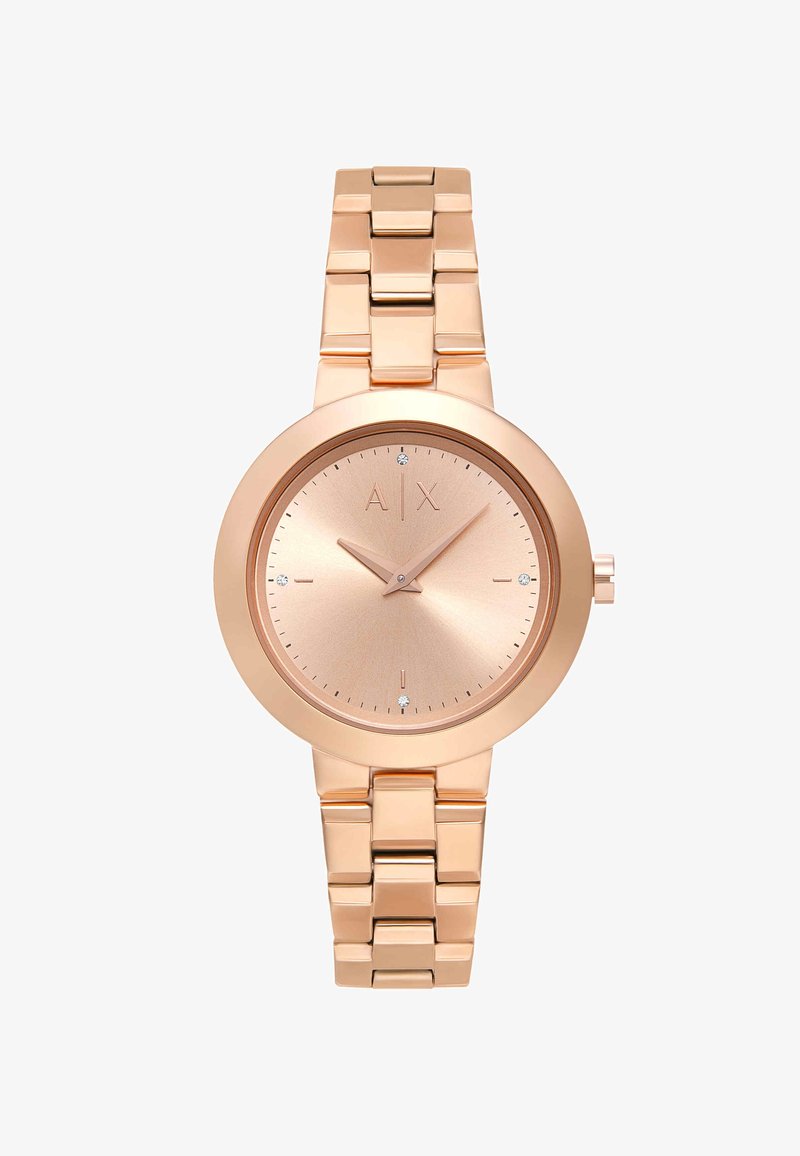 Ruusukultainen metallirannekello, jossa linkitetty ranneke, minimalistinen taulu, jossa näkyy brändin alkukirjaimet A|X ja pienet kristallitunnit merkitsemässä 12, 3, 6 ja 9.