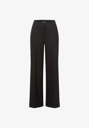 Weite, schwarze Hose aus einem glatten, strukturierten Stoff. Mit einem Bund mit Reißverschluss und verkürzten Bündchen an den Knöcheln.