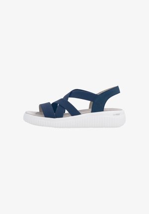 Sandale bleu marine à bout ouvert avec des brides élastiques croisées et une semelle blanche matelassée conçue pour le confort et le soutien.