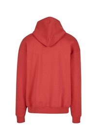Red cotton hoodie with a kangaroo pocket and ribbed cuffs. Features a spacious hood and a relaxed fit, suitable for casual wear.