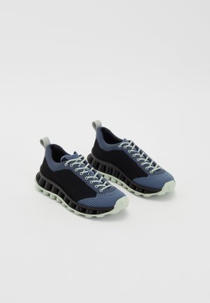 Knitted sneakers in navy and light blue with a cushioned black sole. Features lace-up design and loop heel for easy wear.