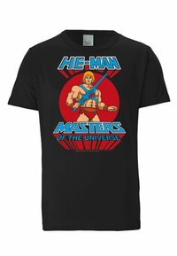 Black t-shirt featuring a graphic of a muscular character holding a sword, with "HE-MAN" and "MASTERS OF THE UNIVERSE" in bright colors.