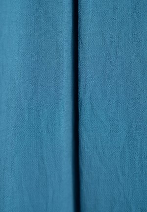 Teal fabric with a soft texture and a subtle weave pattern, featuring a vertical seam for structure and depth.