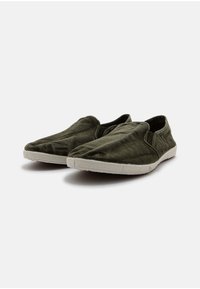Zöld szövetből készült, sima textúrájú, slip-on cipők, fehér gumitalppal és minimális varrási részletekkel. Lekerekített orr és laza kialakítás.