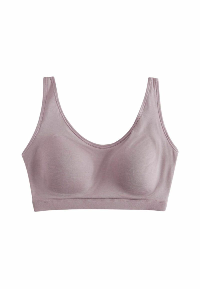 Bralette seamless rose clair avec de larges bretelles, en tissu doux et rembourrage amovible, présentant une texture lisse et sans matériel visible.