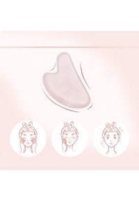 Translucent pink gua sha tool with a curved design. Smooth texture, shaped for facial use. Accompanied by illustrations of facial techniques.