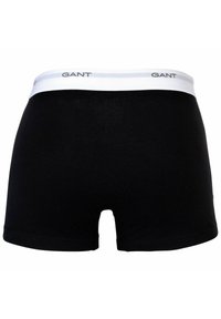 Boxer in cotone neri con una cintura elastica bianca. La cintura presenta il logo "GANT" in grigio.