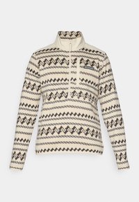 Pullover en polaire beige à manches longues avec des motifs géométriques noirs et beige foncé, un zip quart et une poche poitrine avec le logo Columbia.