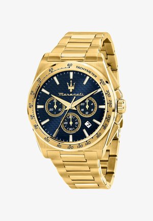 Guldfarvet rustfrit stålukke med en blå tekstureret urskive, tre underdials, tachymeterskala og datovisning. Har lysende visere og markeringer.