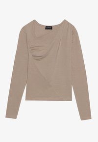 Maglietta a maniche lunghe, beige, realizzata in tessuto morbido. Presenta un design frontale attorcigliato e un scollatura a V. Include una silhouette aderente con cuciture minime.