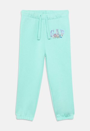 Light blue children's sweatpants with elastic cuffs, drawstring waist, and cartoon animal characters around the "GAP" logo on the upper left leg.