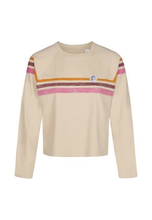 Beige langermet crop top med rund hals, med horisontale rosa, brune og oransje striper over brystet og på overarmene, samt en liten rund logo.