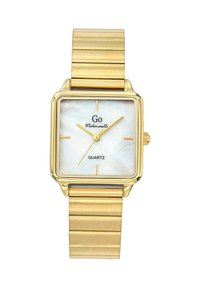 Montre carrée en quartz doré avec un cadran en nacre, dotée d'aiguilles en or jaune et d'un bracelet en maille métallique texturé.