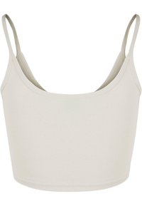 Top cropped blanc, sans couture, avec de fines bretelles réglables. Fabriqué en tissu lisse et extensible, avec un décolleté arrondi et sans fermeture visible.