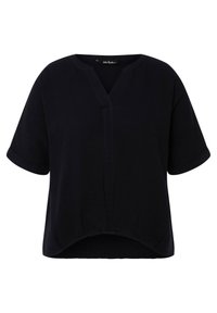 Top nero a maniche corte con scollo a V e vestibilità rilassata. Realizzato in tessuto testurizzato con orlo curvo e sottile dettaglio della cucitura centrale.