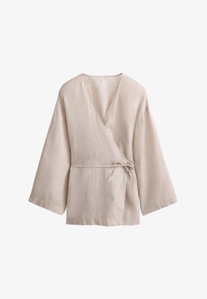 Beżowa lniana bluzka z dekoltem w serek, szerokimi rękawami i zawiązywaniem w talii. Teksturowana tkanina z subtelnym wzorem.