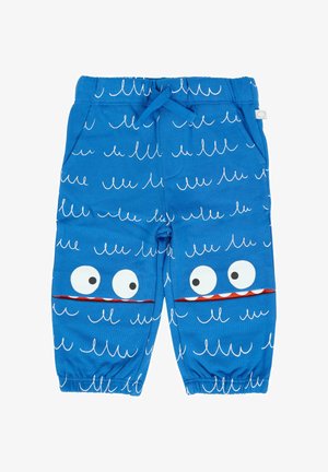 Blauwe peuterbroek met witte golfpatronen, elastische tailleband en zakken die zijn ontworpen als cartoonogen en monden met tanden op de knieën.