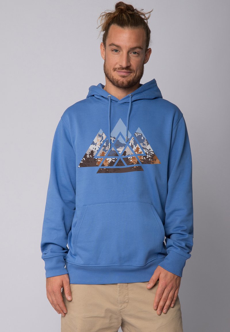 Haut à capuche bleu avec une poche avant présentant un graphique de montagne géométrique dans des tons de gris, marron et orange. Matériau doux, manches côtelées.