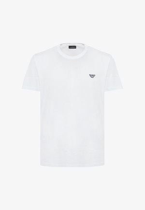 T-shirt bianca a maniche corte con scollo rotondo e piccolo logo aquila nera di Emporio Armani sul petto a sinistra.
