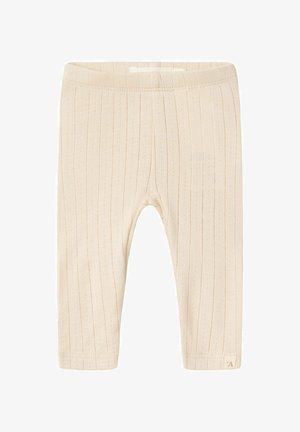 Beige geribde leggings van zachte stof, met een lichte textuur, een elastische tailleband en een klein merklabel aan de zoom.