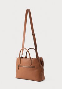 Brown leather bag with a structured silhouette, two top handles, and a detachable shoulder strap. Features a zippered front pocket and textured finish.