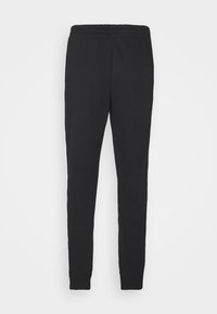 Pantalones de chándal negros de algodón, con un diseño ajustado, cinturilla elástica y puños. Textura suave sin patrones ni herrajes visibles.