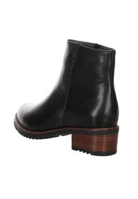 Botín de cuero negro con punta redonda, acabado texturizado y un tacón de madera de altura media. Presenta una silueta sencilla y detalles de costura.