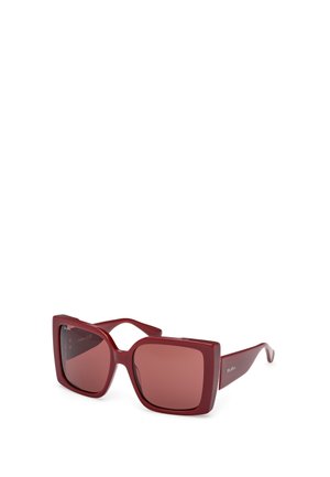 Red oversized sunglasses with square frames and tinted lenses. Made of plastic with smooth texture and subtle branding on the arm.