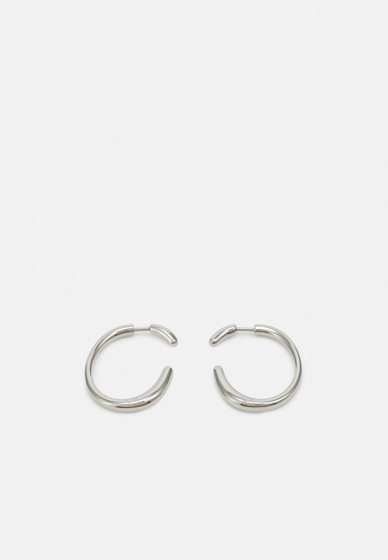 Strieborné kruhové náušnice s hladkým, zaobleným dizajnom a elegantným, lesklým povrchom. Majú minimalistický tvar s jemným otvorom.