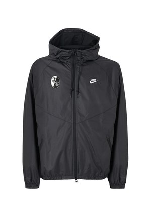 Sort Nike hættejakke med lynlås med SC Freiburg fodboldklub-logo på brystet og elastiske manchetter og kant.
