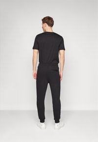 HUGO DOAK - Pantaloni de trening - black