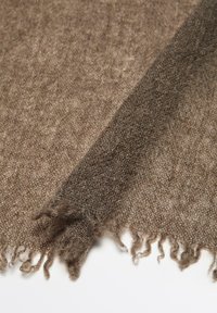 Brown woven scarf with a soft texture, featuring frayed edges and a gradient from light to dark at one end. Lightweight fabric.