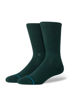 Dark green ribbed socks with a logo detail and contrasting blue accents on the toes. Made from soft, stretchable material.