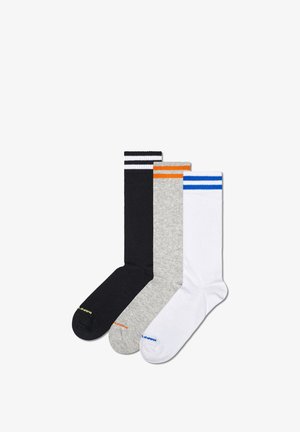 Three pairs of crew socks: black with white stripes, gray with orange stripe, and white with blue stripe. Fabric is smooth and stretchy.