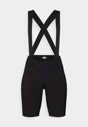 Schwarze Radshorts mit X-förmigen Trägern, aus dehnbarem Material. Verfügt über einen gepolsterten Sitzbereich und eine glatte Textur.