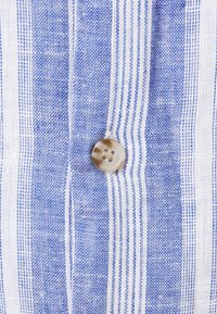 Blue and white striped fabric with a woven texture; features a rounded, shiny button at the center.