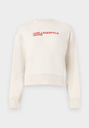 Bílá krátká mikina s dlouhými rukávy s červeným logem "KARL LAGERFELD JEANS" vytištěným přes hruď.