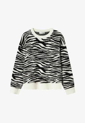 Svart og hvit stripete genser med myk tekstur, rund hals og ribbestrikkede mansjetter og nederkant. Har et sebramønster over hele genseren.