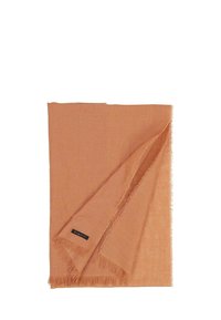 Orange woven scarf with fringed edges, featuring a soft texture and a subtle stripe pattern. Branding label visible on one edge.
