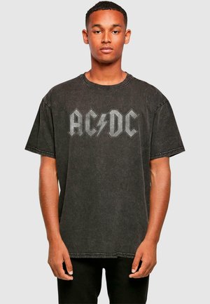 Black graphic t-shirt featuring AC/DC logo in gray with lightning bolt. Made from cotton, loose fit, short sleeves, with a distressed texture.