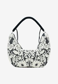 Schwarz-weiße bestickte Handtasche mit floralen Mustern, aus weichem Stoff, runder Form und einem gerillten schwarzen Griff für besseren Halt.