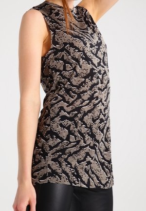 Sleeveless black and gray patterned top worn with black pants, showing side and arm of person against plain light background.