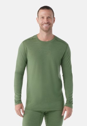 Langsleeve, nauwsluitend sportshirt van gestructureerde groene stof, met een ronde halslijn en naadloos schouderontwerp.