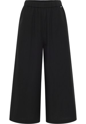 Mustad laiad püksid, mis on valmistatud kergest kangast ja millel on elastsest materjalist vöökoht. Omavad siledat tekstuuri ja minimaalset disaini, ilma taskuteta.