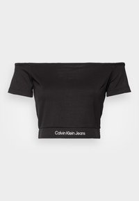 Top corto negro sin hombros hecho de material suave, con mangas cortas y un estampado de logo "Calvin Klein Jeans" en el dobladillo.
