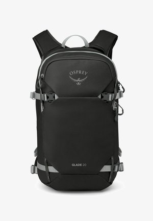 Sac à dos Osprey Glade 20 noir avec des accents gris, doté de bretelles ajustables, d'une poche frontale et de sangles de compression latérales pour un ajustement sécurisé.