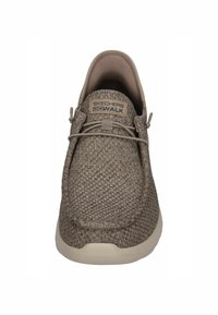 Skechers GoWalk shoe in light brown, features a textured knit upper, lace-free design, and a light-colored sole. Accented with logo detailing.