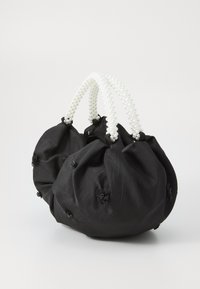 Borsa in tessuto nero con design arricciato, adornata con piccoli fiori neri e con due manici simili a perle.