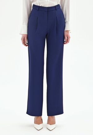 - Spodnie materiałowe